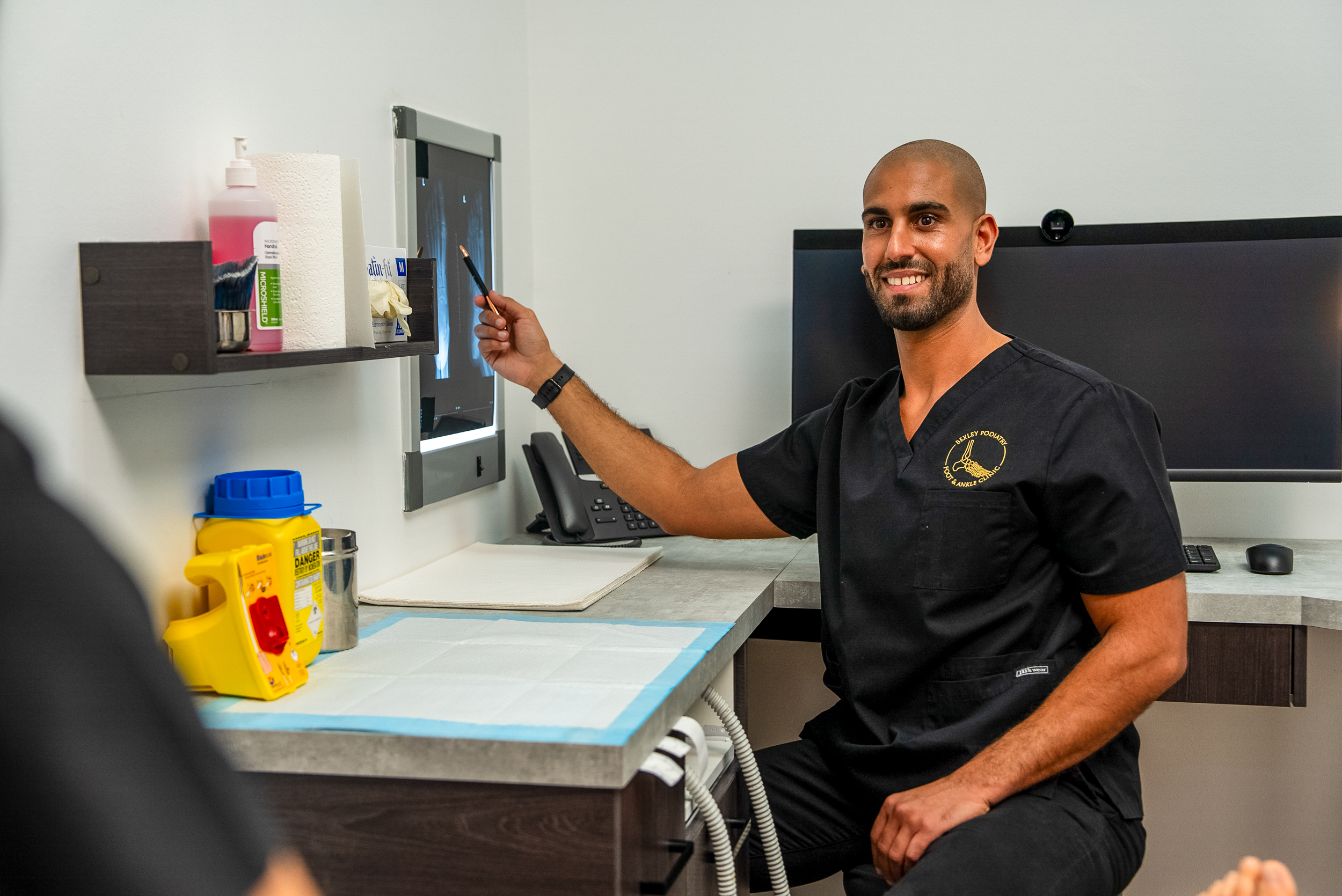 Bexley Podiatry podiatrist reviewing a foot X-ray with a patient
