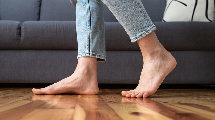 A podiatrist assessing a patient's feet in the Bexley Podiatry clinic