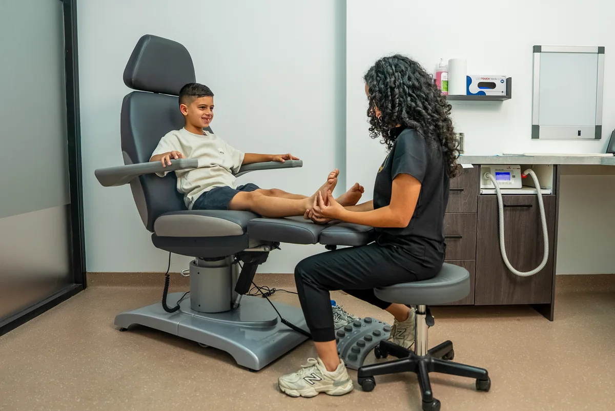 A podiatrist assessing a child with a parent present at the Bexley clinic