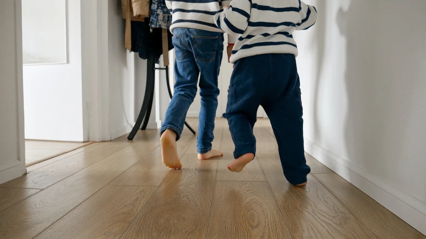 A podiatrist reassuring a parent while checking their child's feet