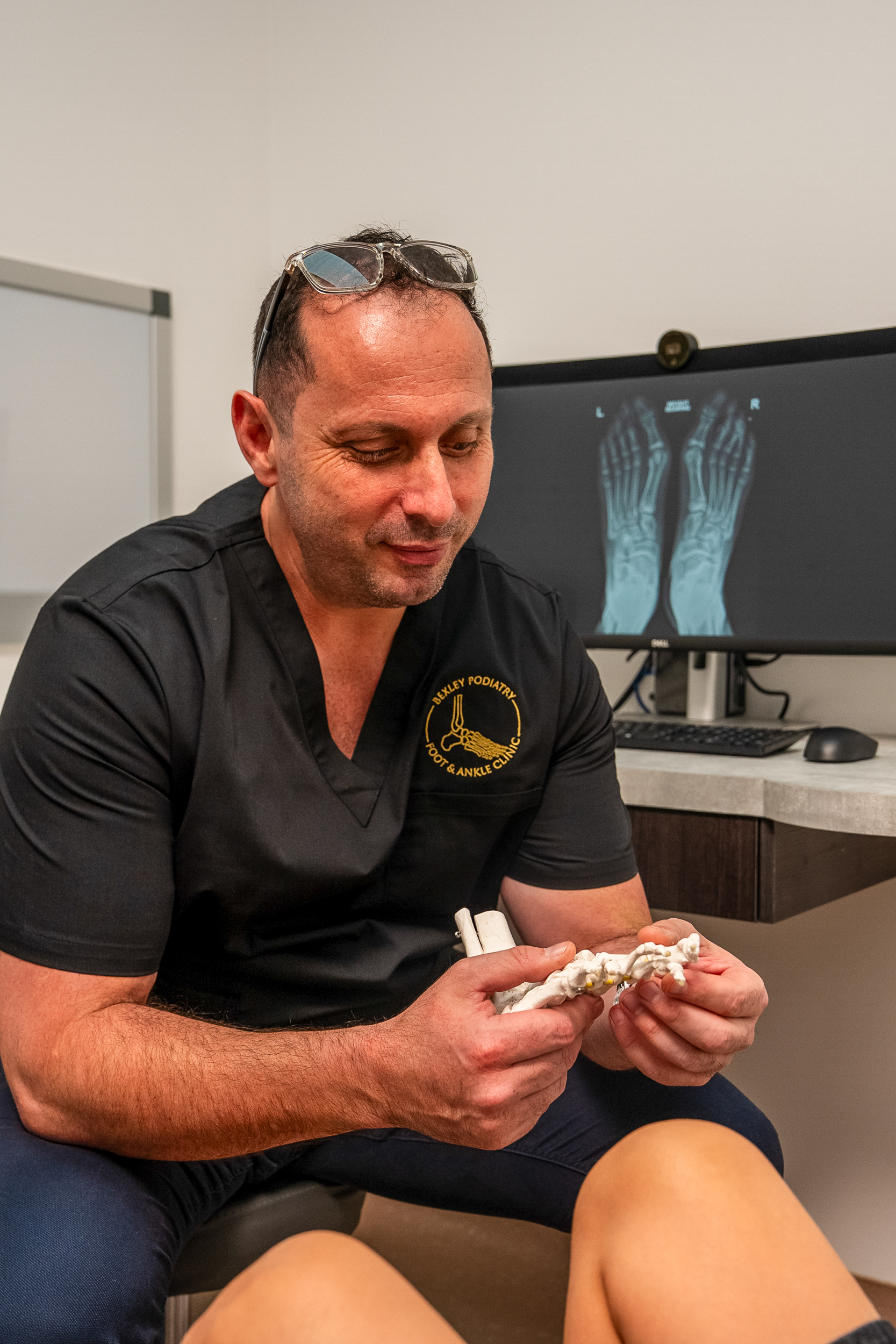 A Bexley Podiatry podiatrist checking a patient's foot in the clinic