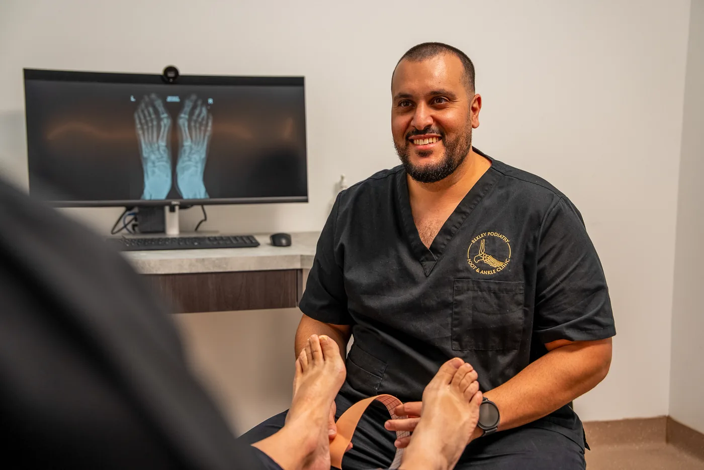 A podiatrist assessing a patient's foot and ankle at Bexley Podiatry: Foot & Ankle Clinic